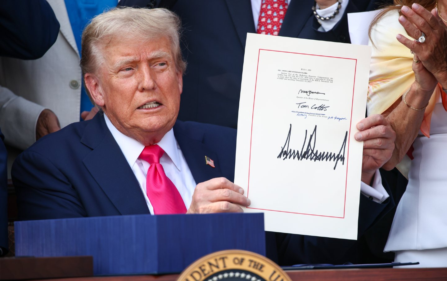 Donald Trump signs the One, Big Beautiful Bill Act into law during an Independence Day military family picnic on the South Lawn of the White House on July 4, 2025, in Washington, DC.