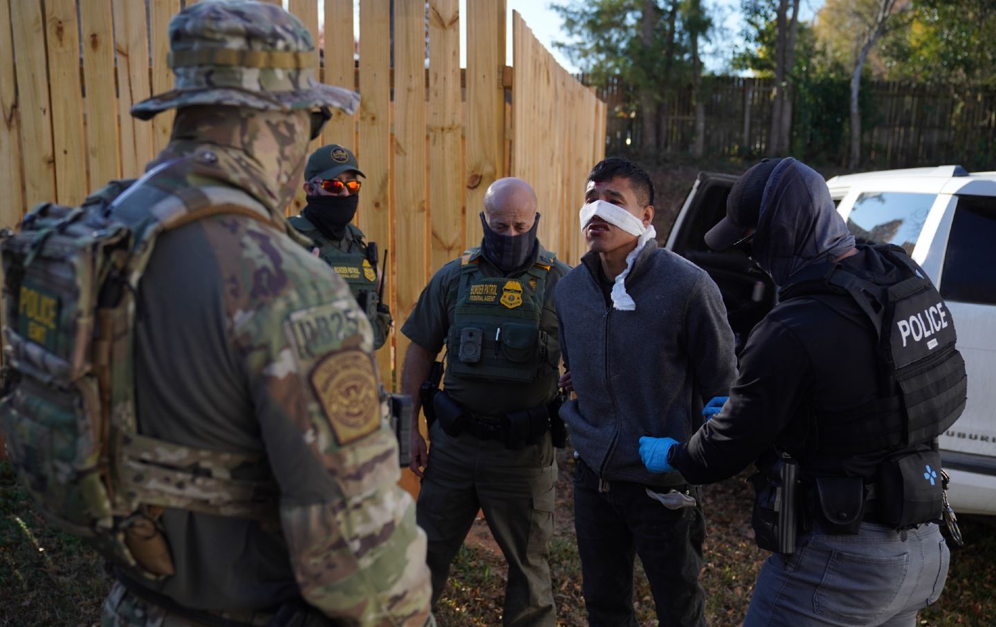 A man is detained by CBP officers