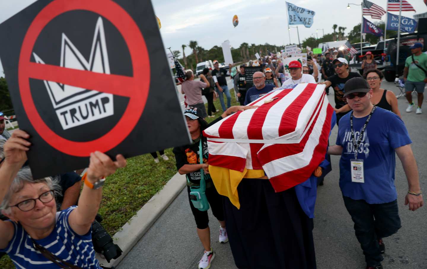 Protesters carry a coffin symbolizing the death of democracy near Donald Trump's Mar-a-Lago home.