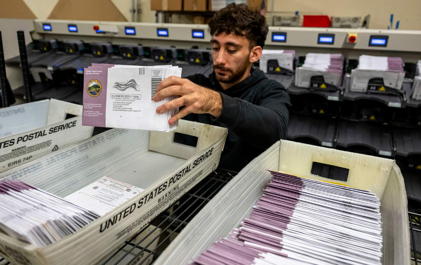 An election worker sorts mail-in ballots for the 2024 presidential election in Martinez, California, on Election Day.