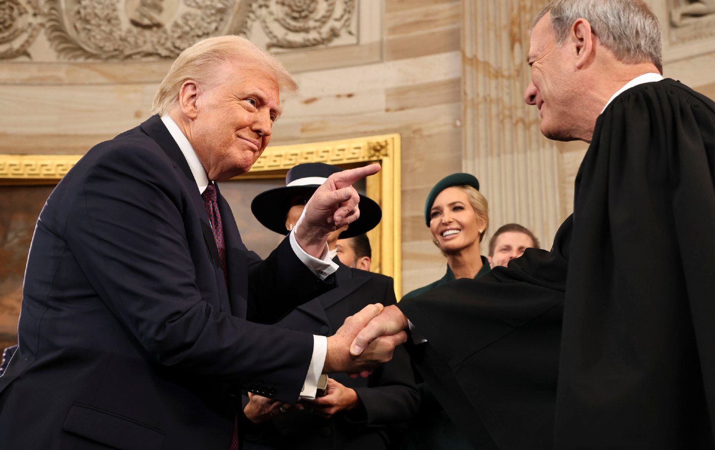 US President Donald Trump and John Roberts, chief justice of the US Supreme Court, shake hands during the 60th presidential inauguration on January 20, 2025.