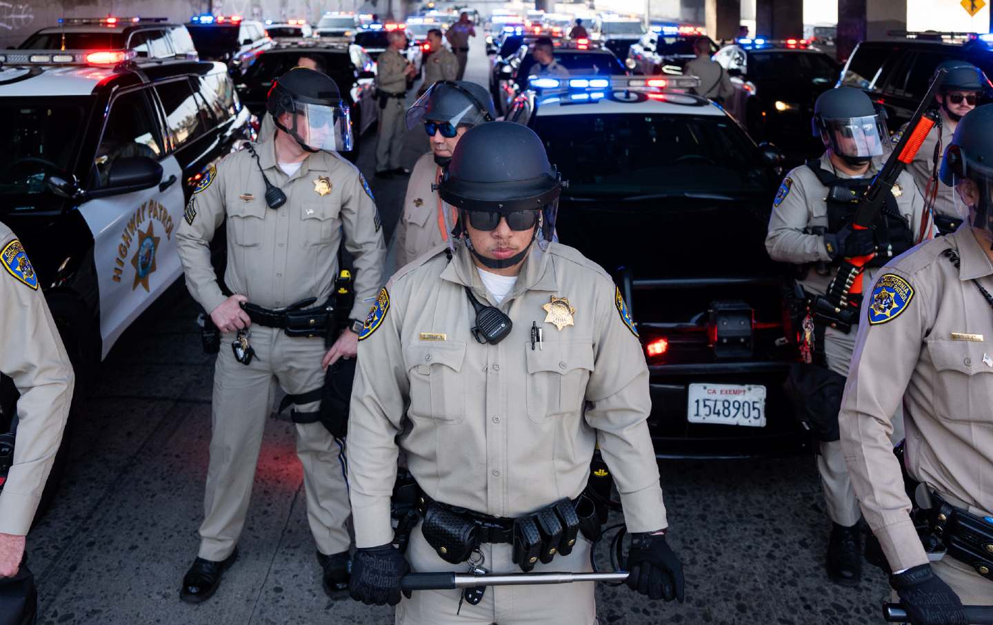 Police officers and cars block off a freeway.