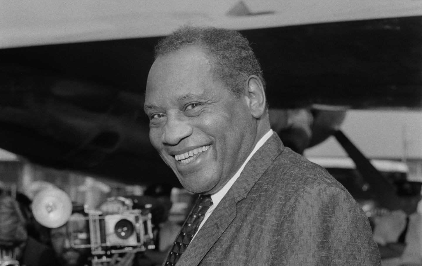 Paul Robeson smiles at London Airport, July 11th 1958.