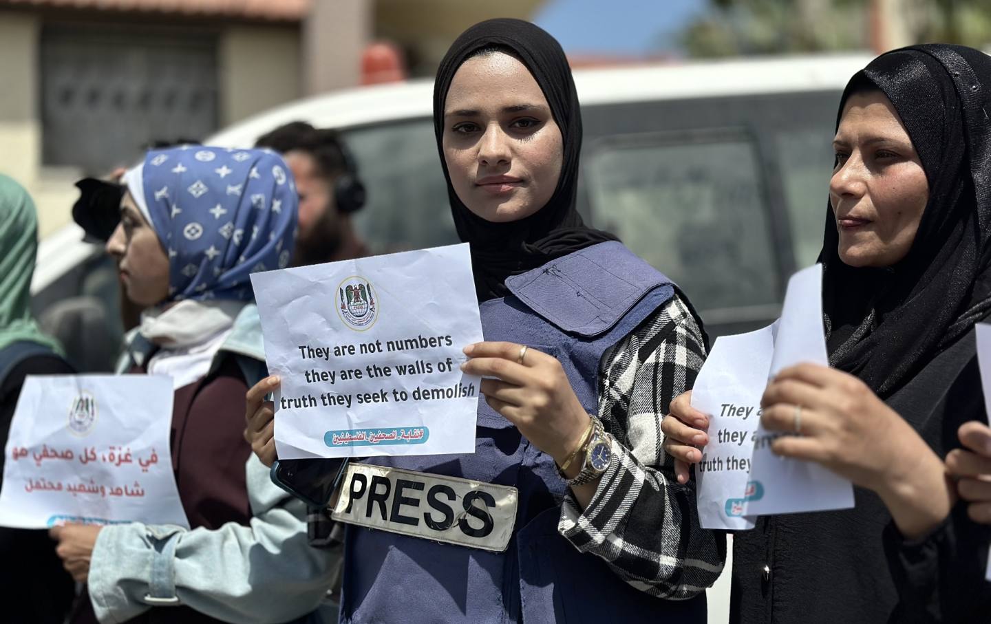 Journalists, holding banners, gather for a demonstration to draw attention to the journalists, who lost their lives in Israeli attacks, during 