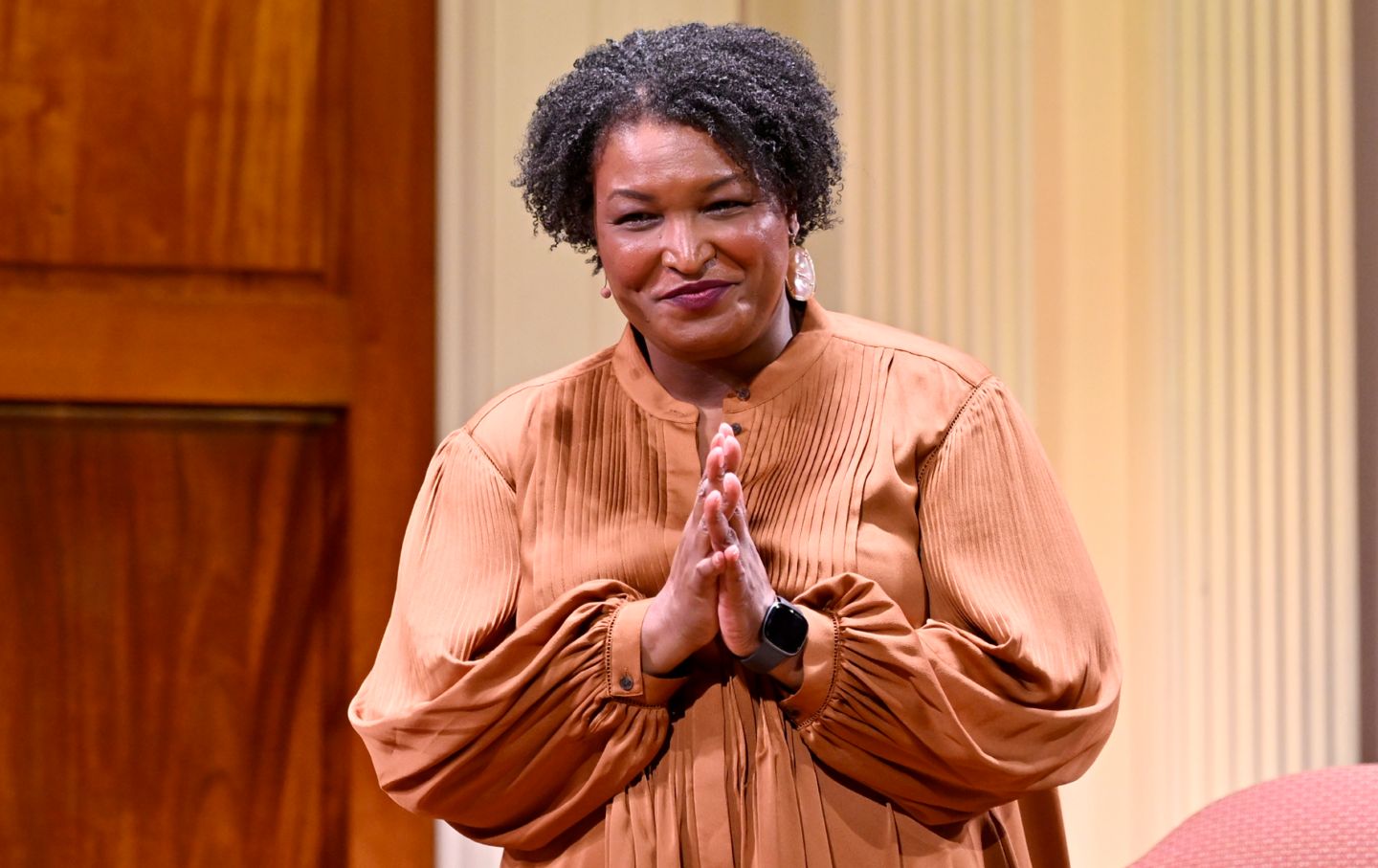Stacey Abrams discusses her new novel on stage during 