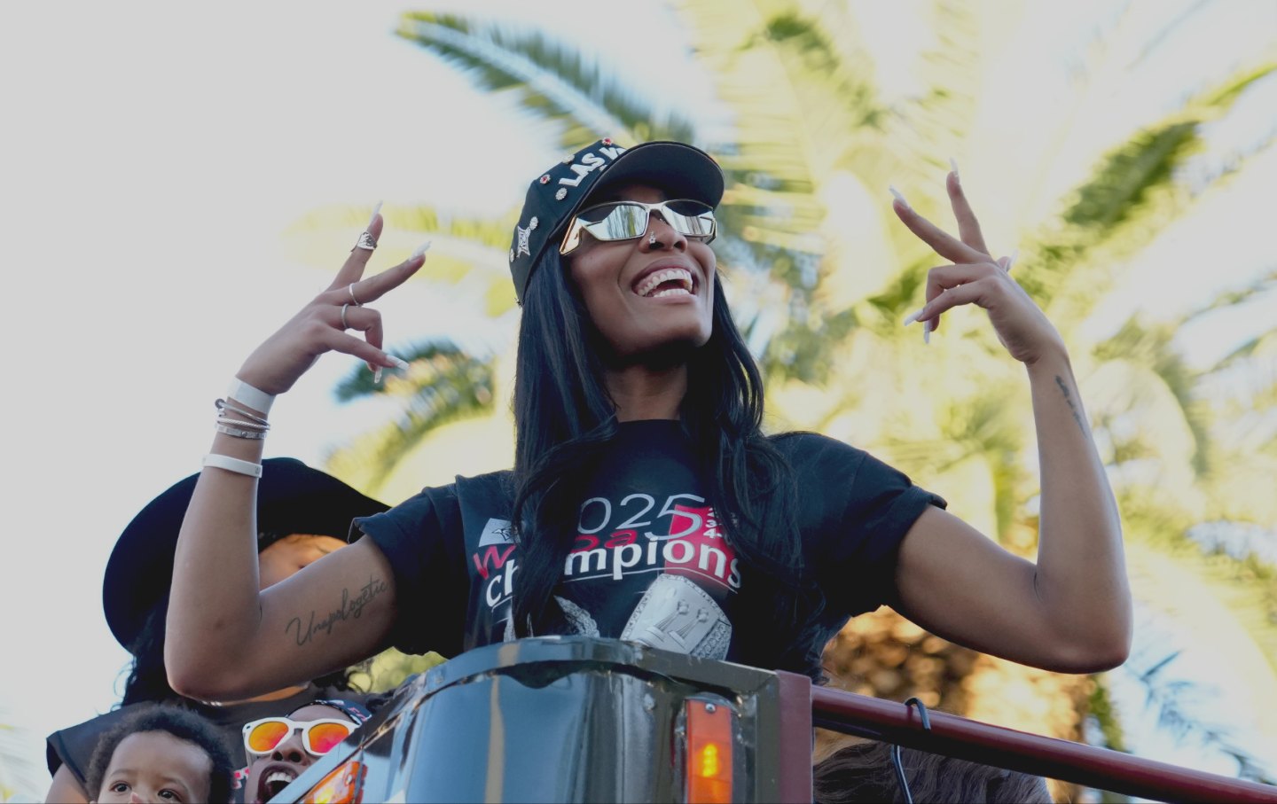 A'ja Wilson #22 of the Las Vegas Aces poses as she rides on top of a bus during the Las Vegas Aces WNBA championship victory parade and rally on Las Vegas Boulevard on October 17, 2025 in Las Vegas, Nevada.