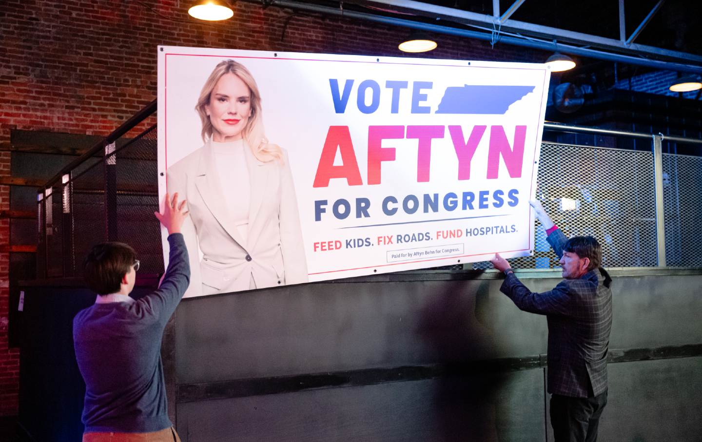 Volunteers mount a campaign poster for Aftyn Behn on December 2, 2025, in Nashville, Tennessee.