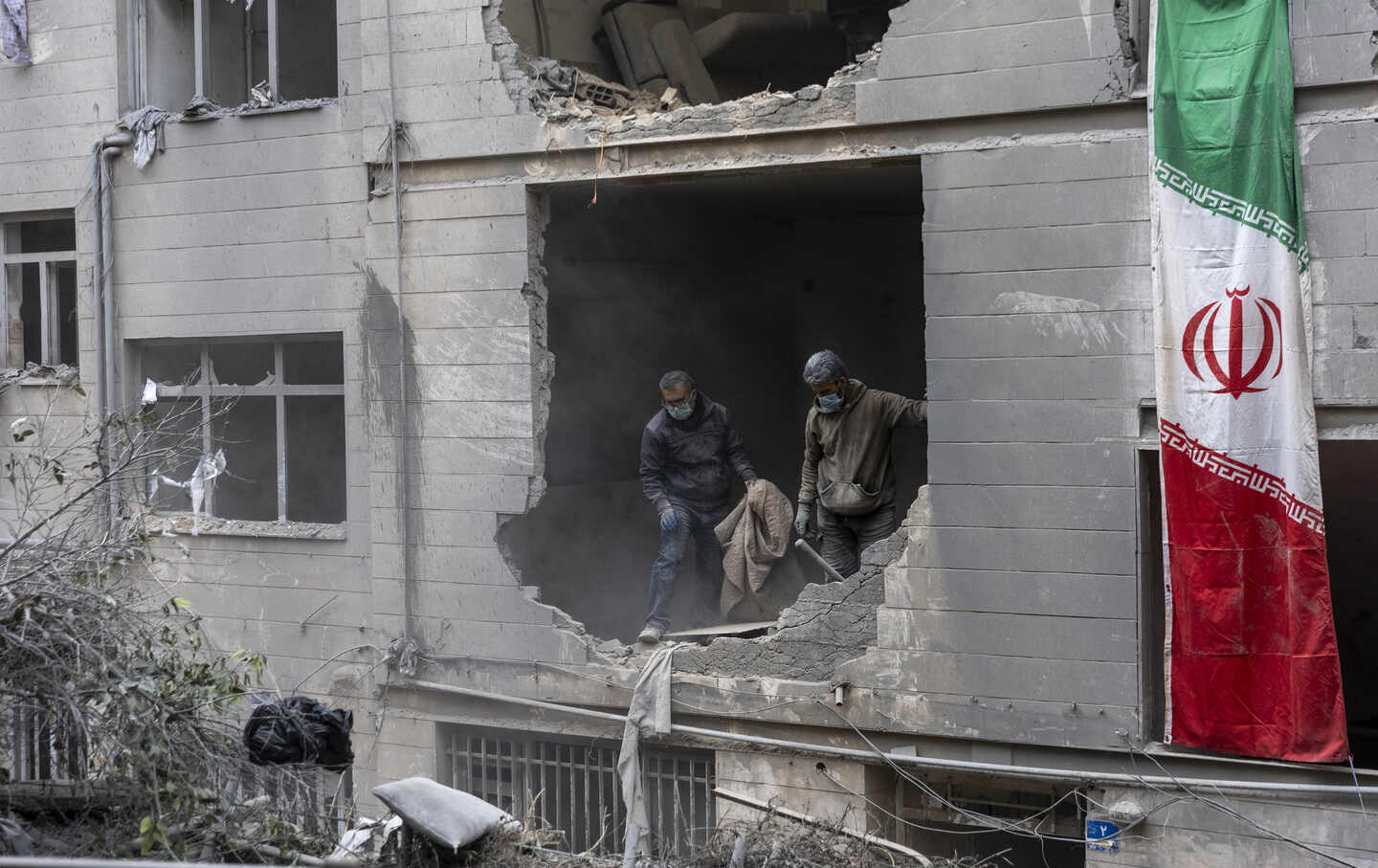 People clear rubble in a house in the Beryanak District after it was damaged by missile attacks two days before, on March 15, 2026, in Tehran, Iran.