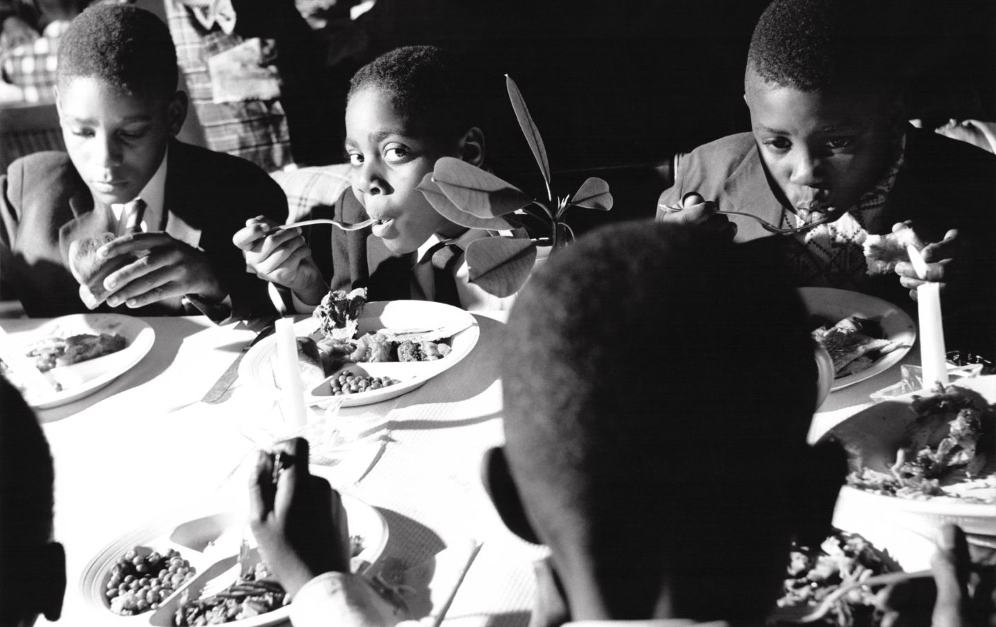 Children eating Thanksgiving dinner in Harlem.