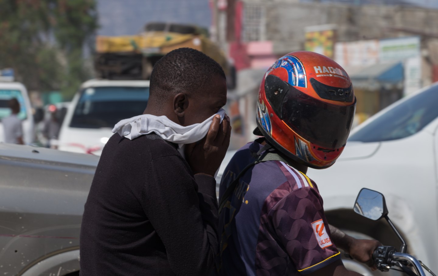 Motorcyclist and passenger riding in the streets of Port-Au-Prince, Haiti, on February 27, 2025. Although gang violence is omnipresent in the capital, daily life continues as usual.