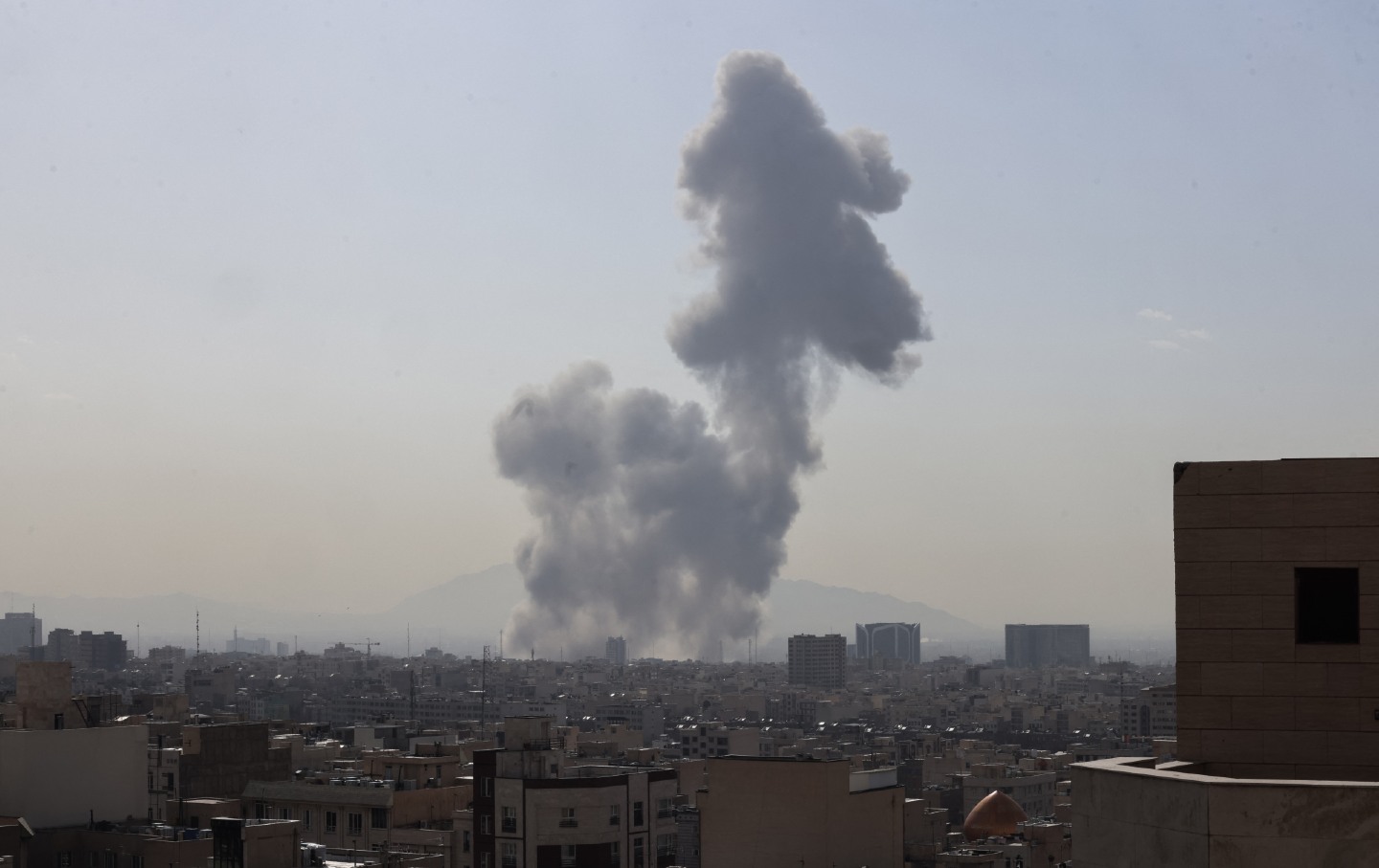 A plume of smoke rises following a reported explosion in Tehran on February 28, 2026.