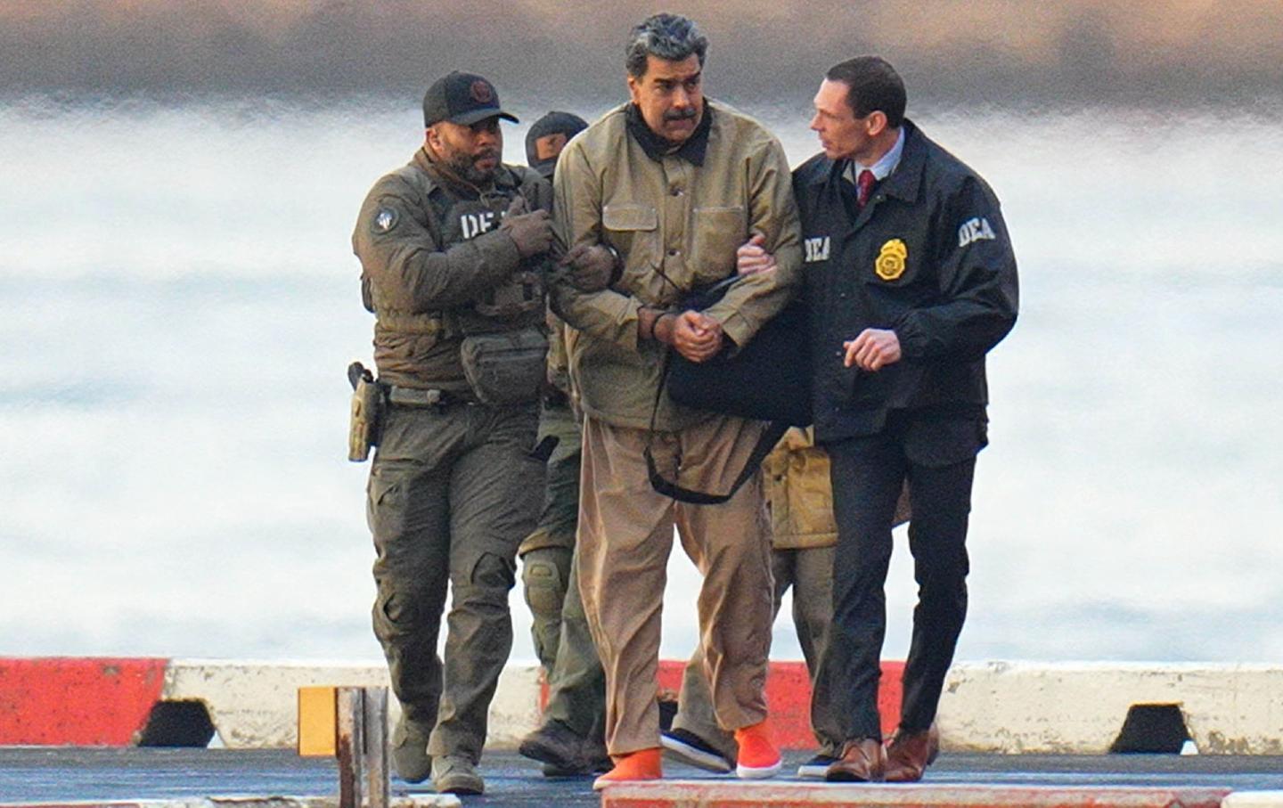 Nicolas Maduro is seen in handcuffs after landing at a Manhattan helipad.