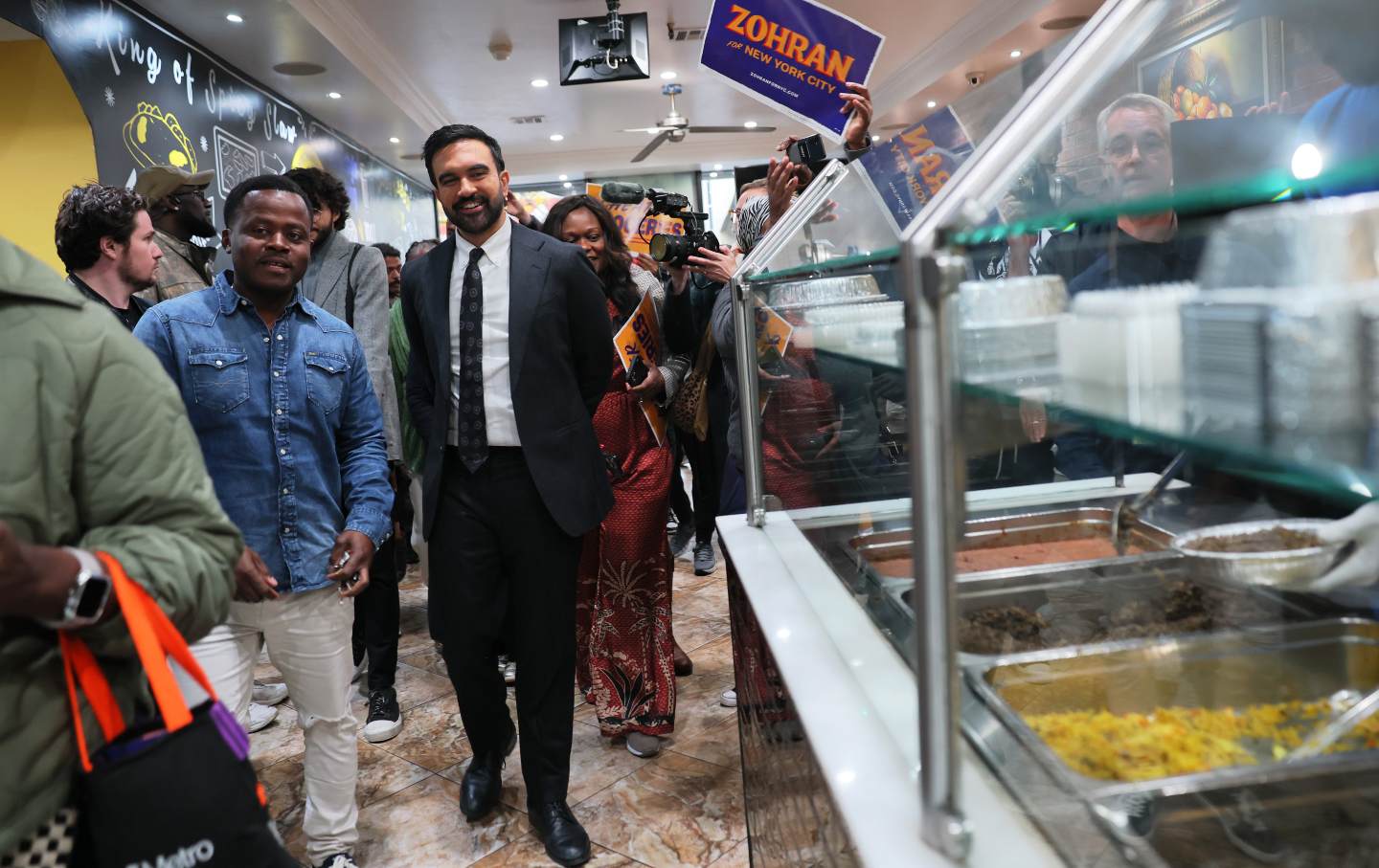 Mayor Mamdani walks inside Kreyol Flavor with its owner, Cursy Saint Surin, in the neighborhood of East Flatbush, Brooklyn, on October 25, 2025.