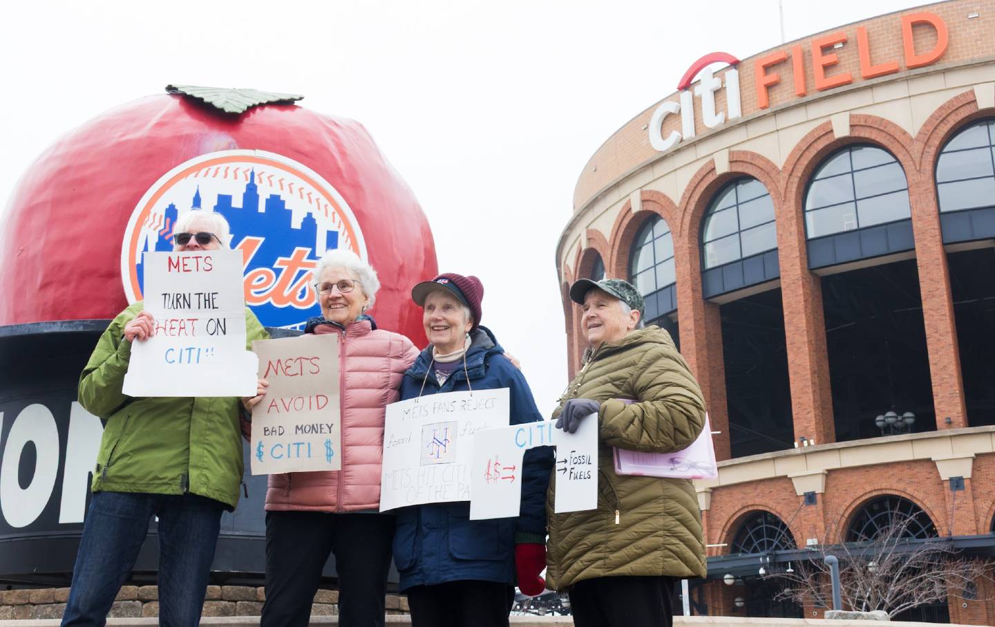 Protesters gather outside of Citi Field to object to the Mets' partnership with Citibank.