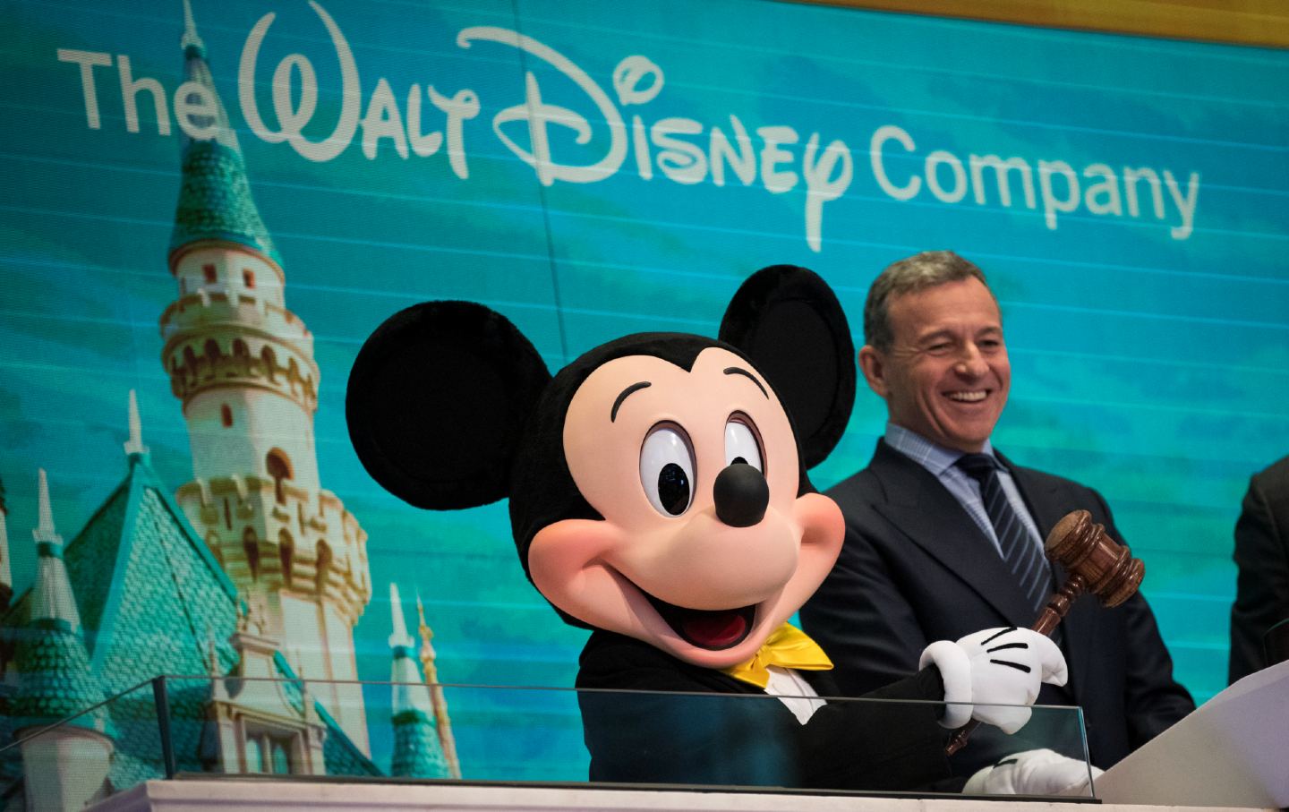 Mickey Mouse, left, and chief executive officer and chairman of The Walt Disney Company Bob Iger prepare to ring the opening bell at the New York Stock Exchange on November 27, 2017, in New York City.