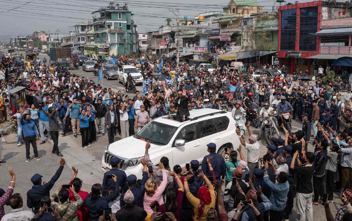 Nepali Rastriya Swatantra Party prime ministerial candidate Balendra Shah waves to supporters during a campaign roadshow in the district of Jhapa on March 1, 2026, in Bidhabare, Nepal.