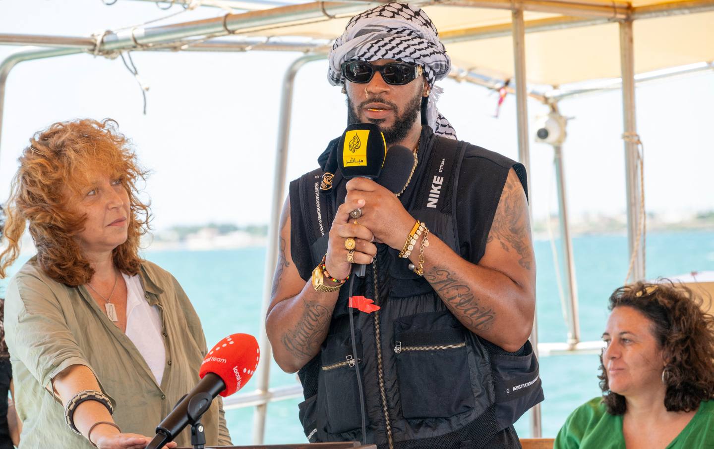 US cofounder and the former president of the Amazon Labor Union Chris Smalls (C) addresses a press conference on the Freedom Flotilla ship “Handala” ahead of the boat's departure for Gaza at a port in Syracuse, Sicily, southern Italy, on July 13, 2025.