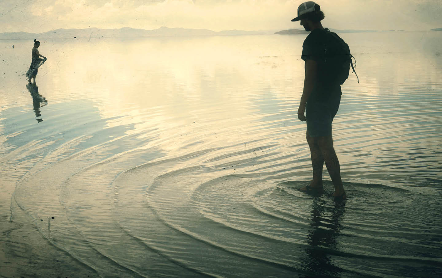 People wade in the shallow waters of the Great Salt Lake at Antelope Island in August 2021.