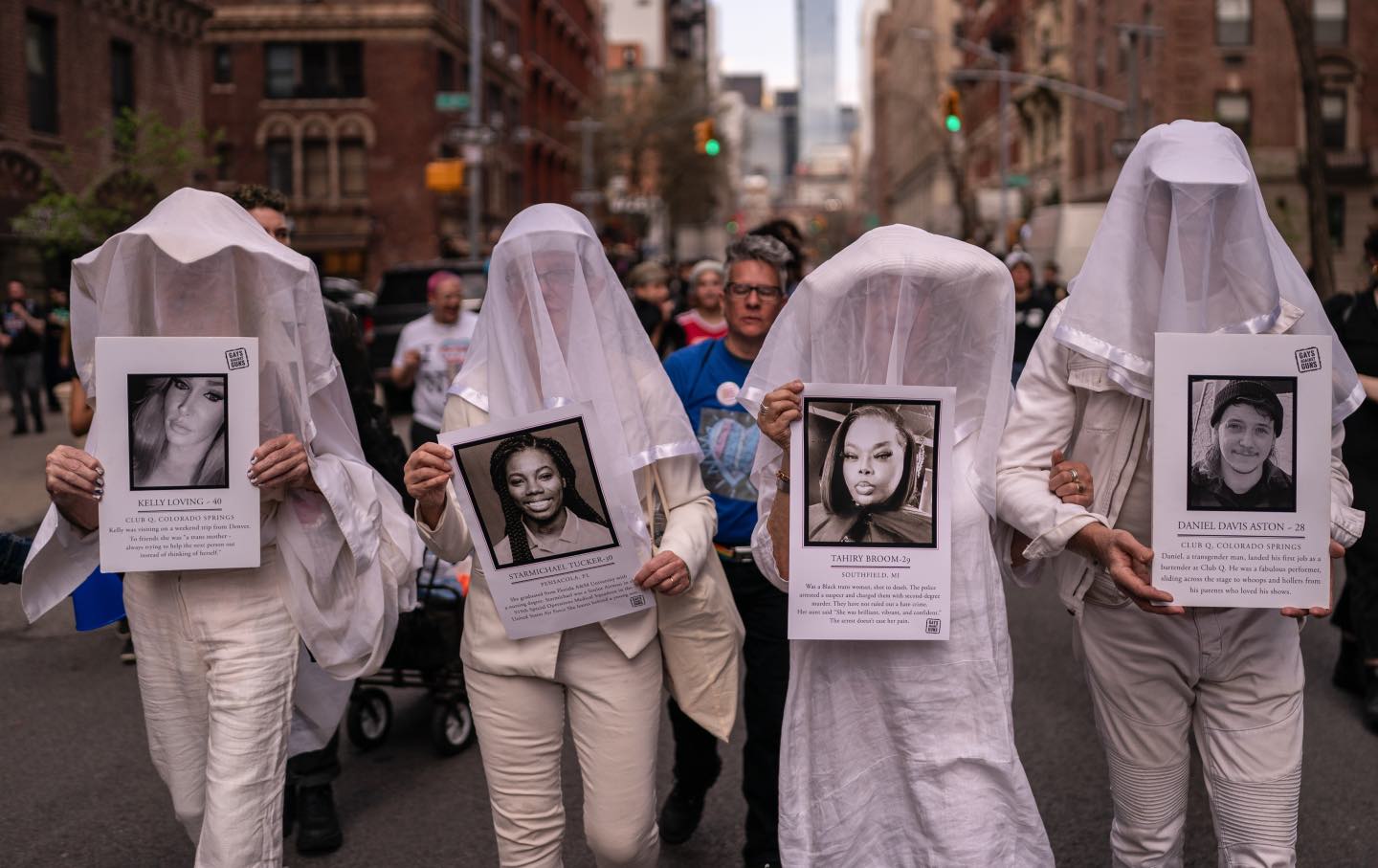 Demonstrators hold photographs during a rally for Trans Day of Visibility in New York City on March 31, 2025.