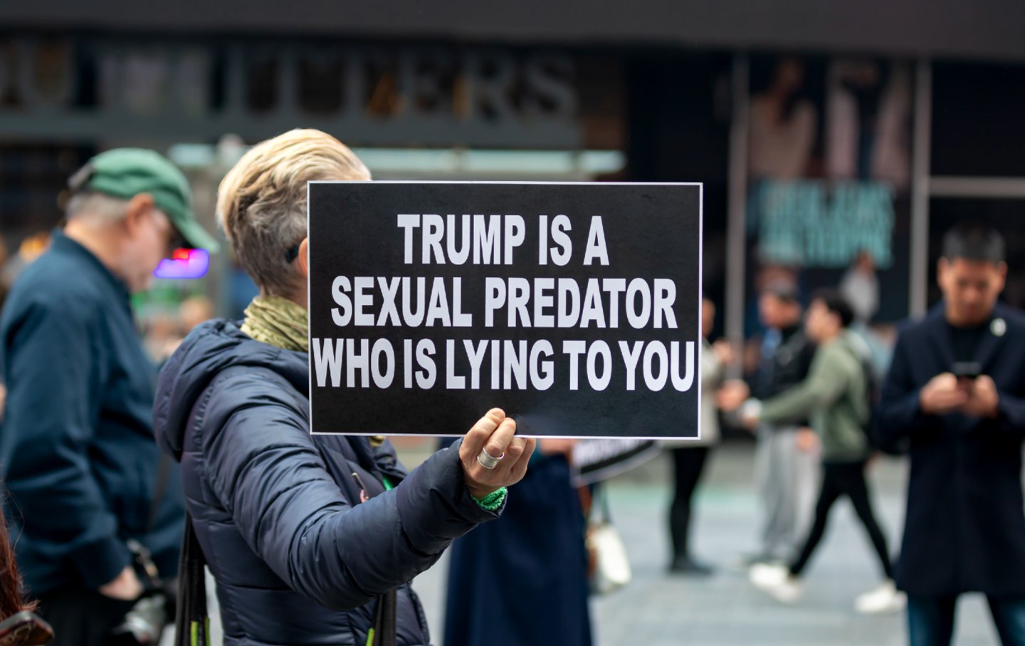 A demonstrator carries sign in support of the victims of sex offender Jeffrey Epstein and against Donald Trump’s refusal to release what are known as the Epstein files in New York’s Times Square.