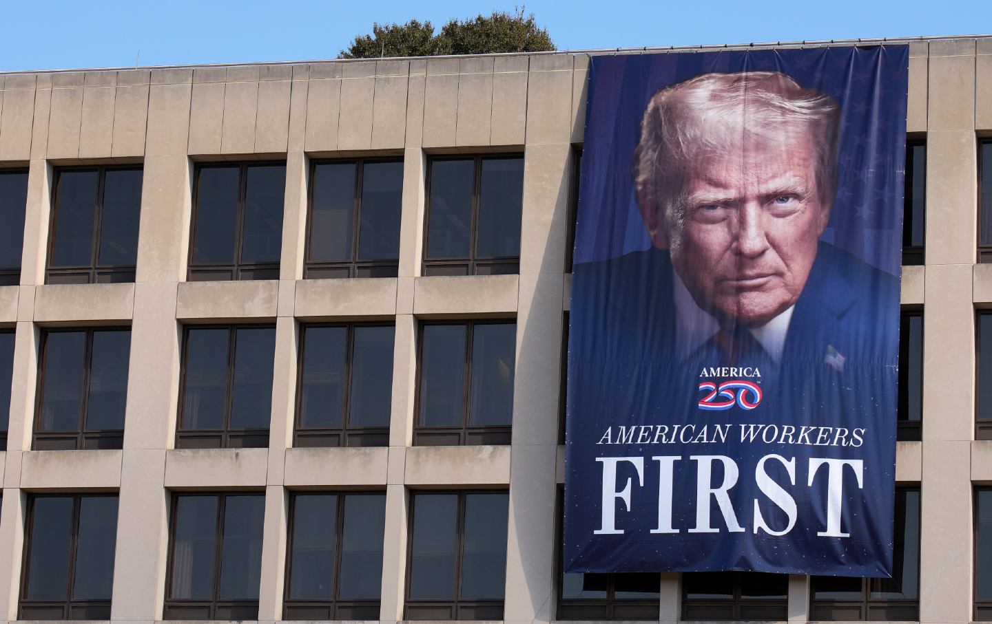 A photo of President Donald Trump is displayed on the side of the US Department of Labor on August 25, 2025, in Washington, DC.