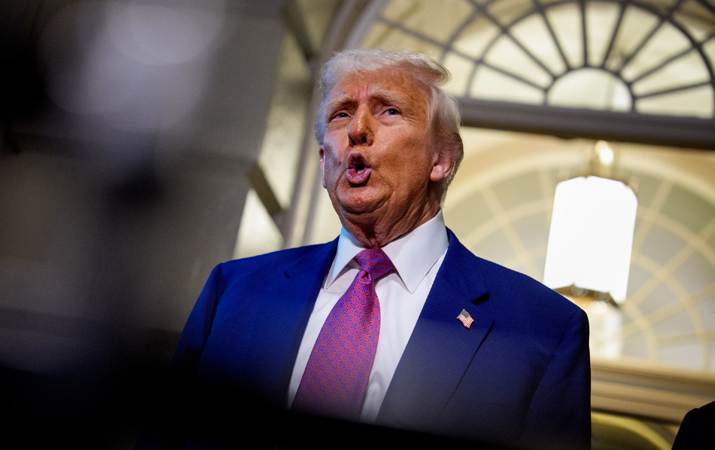 Donald Trump speaks to members of the media as he departs a House Republican meeting at the US Capitol on May 20, 2025, in Washington, DC. Trump joined conservative House lawmakers to help push through their budget bill after it advanced through the House Budget Committee on Sunday evening.