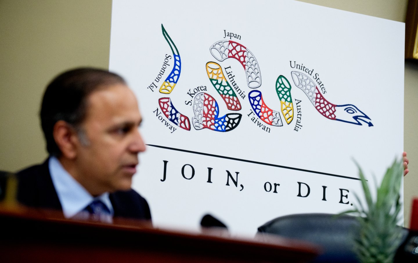 Ranking Member Representative Raja Krishnamoorthi (D-IL) displays a reimagined depiction of a “Join, or Die” poster displaying country names along a cut-up snake as he speaks during a House Select Committee on the Chinese Communist Party hearing on Capitol Hill, Washington, DC, on July 23, 2025.